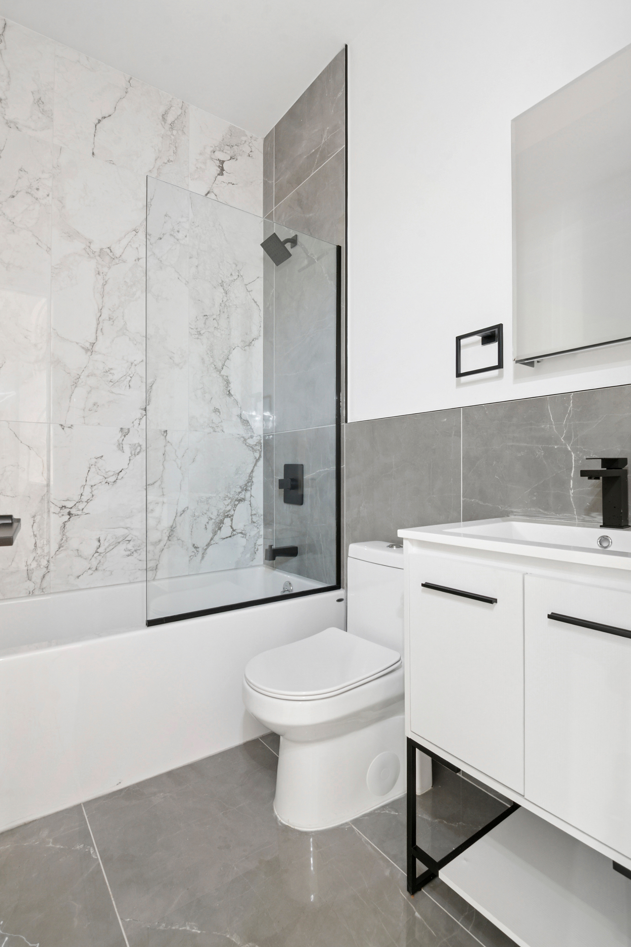 Modern bathroom with marble tile and matte black fixtures