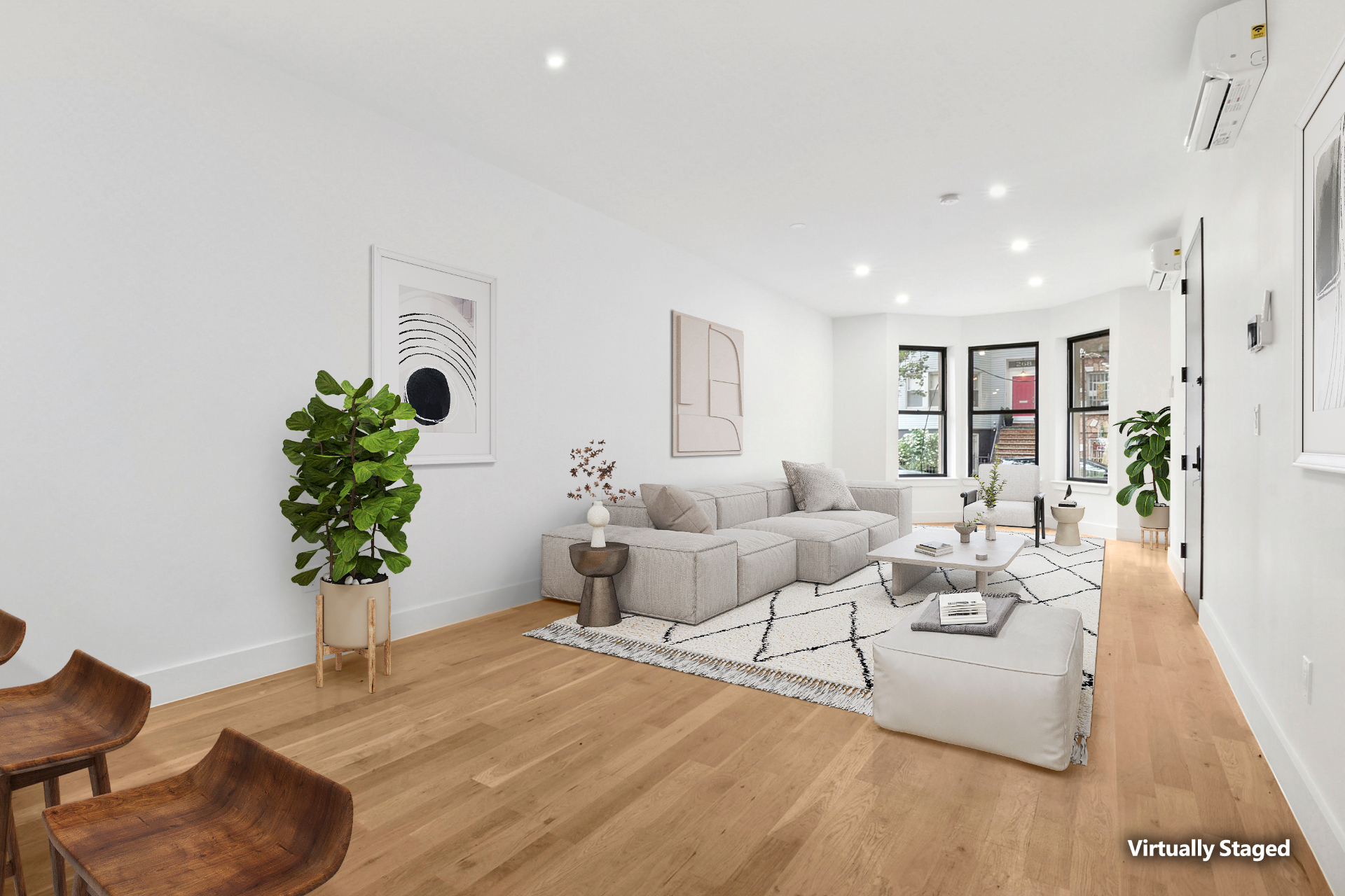 Bright staged living room with bay windows