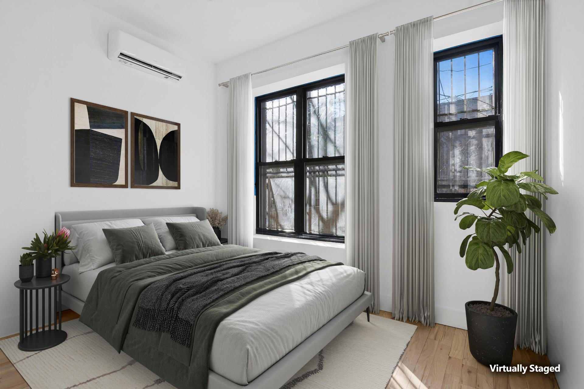 Staged bedroom with abstract art and fiddle-leaf fig